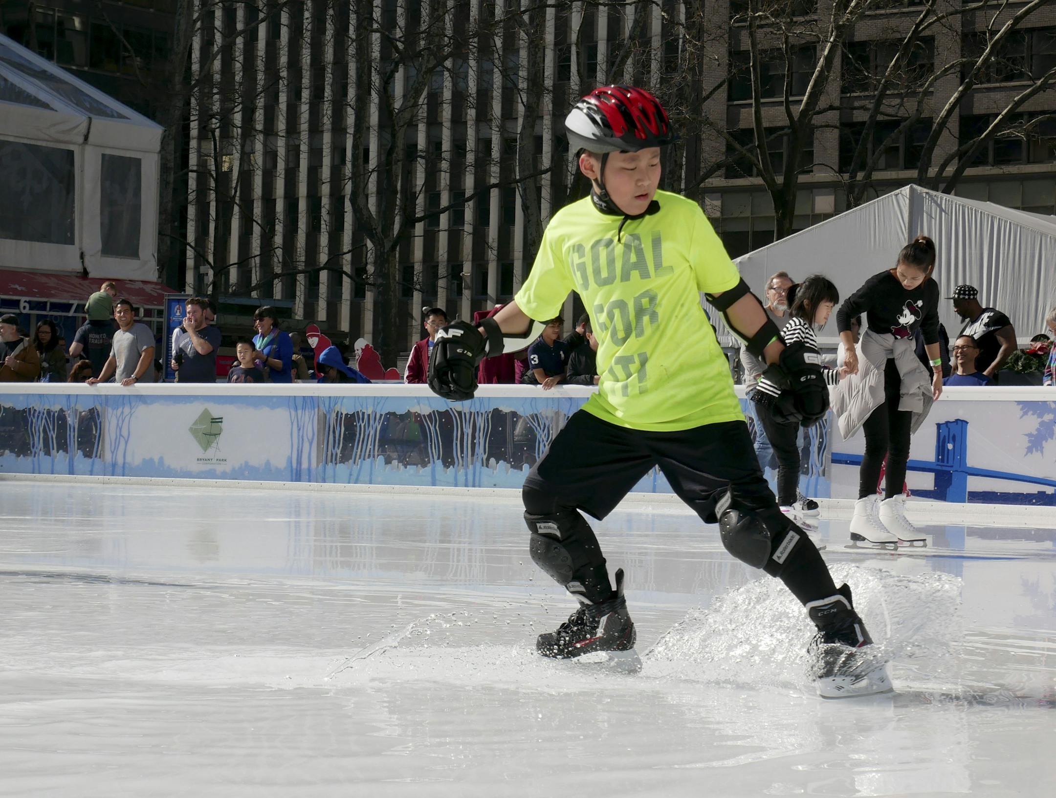 A skater kicks up water while trying to stop in a puddle at an outdoor ice rink in New York, Wednesday, Feb. 21, 2018. (AP Photo/Seth Wenig)