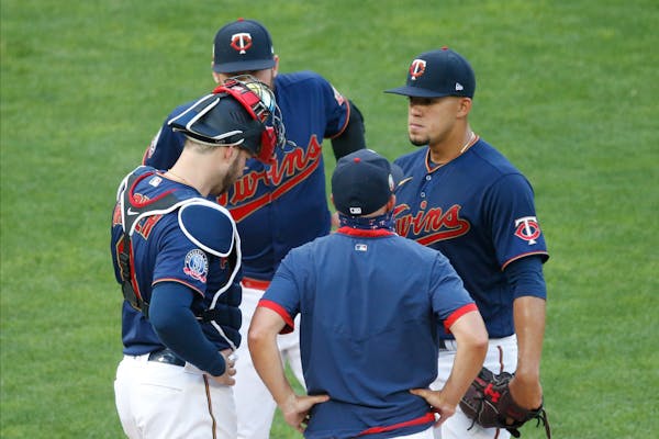 Twins pitcher Jose Berrios, right, gets a mound visit from pitching coach Wes Johnson after giving up a two-run home run to Cleveland's Francisco Lind