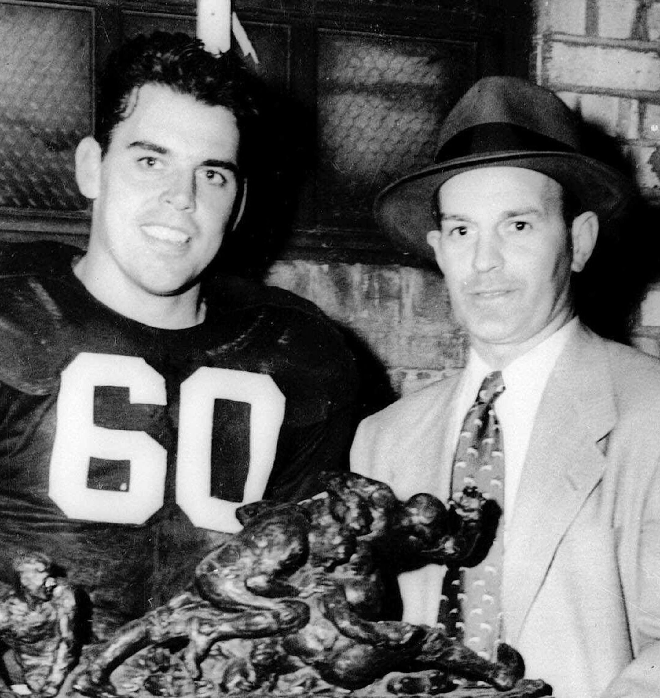 Otto Graham (60) star passing quarterback of the Cleveland Browns and his coach Paul Brown, hold the Robert French Memorial Trophy after Graham was selected as Most Valuable Player in the NFL opener. Graham passed for three touchdowns and scored a fourth in the Sept.16, 1950 opener which Cleveland won 35 to 10. (AP photo) ORG XMIT: APHS204