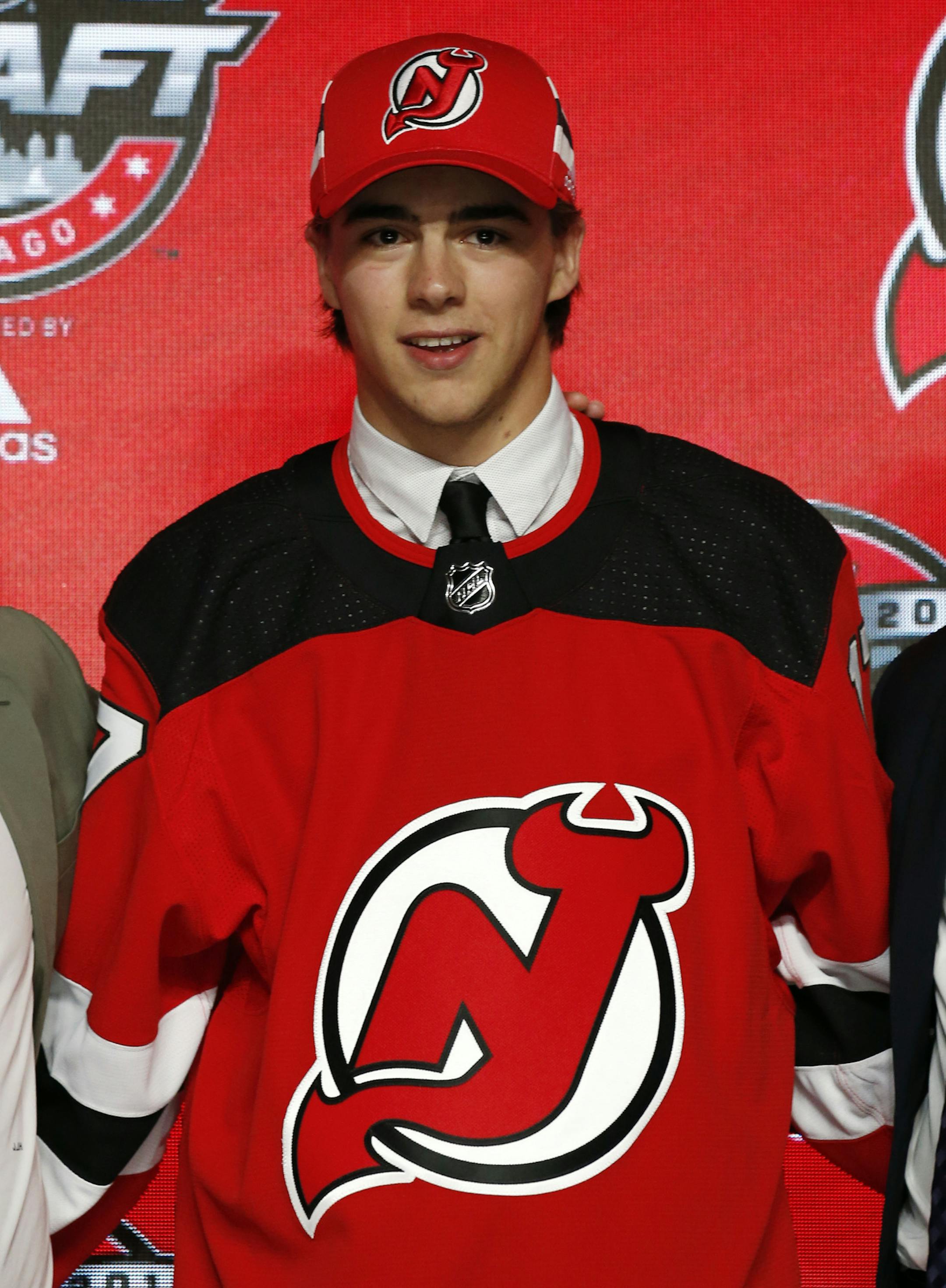 Center Nico Hischier holds a New Jersey Devils jersey after being selected by the team in the first round of the NHL hockey draft, Friday, June 23, 2017, in Chicago. (AP Photo/Nam Y. Huh)