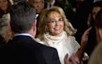 People applause for former Arizona Rep. Gabby Giffords as she arrives in the East Room of the White House in Washington, Tuesday, Jan. 5, 2016, to hea