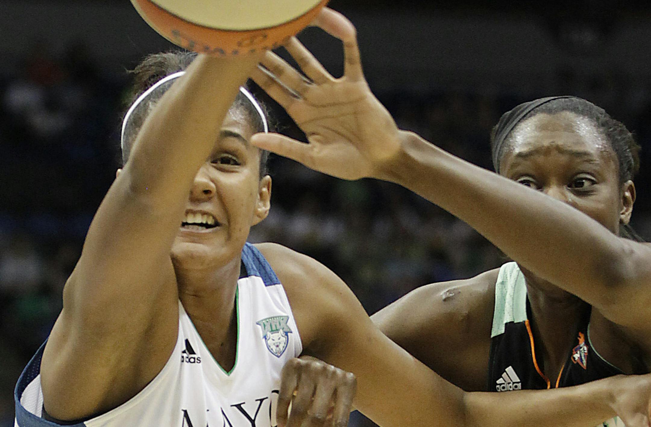Minnesota Lynx forward Damiris Dantas (34) and New York Liberty center Tina Charles (31) reach for the ball in the first half of a WNBA basketball game, Saturday, May 24, 2014, in Minneapolis. (AP Photo/Stacy Bengs) ORG XMIT: MIN2014052919155807