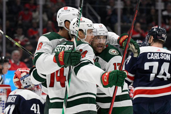 Minnesota Wild center Joel Eriksson Ek (14) celebrates his goal with left wing Marcus Foligno (17) and left wing Jordan Greenway (18) during the secon