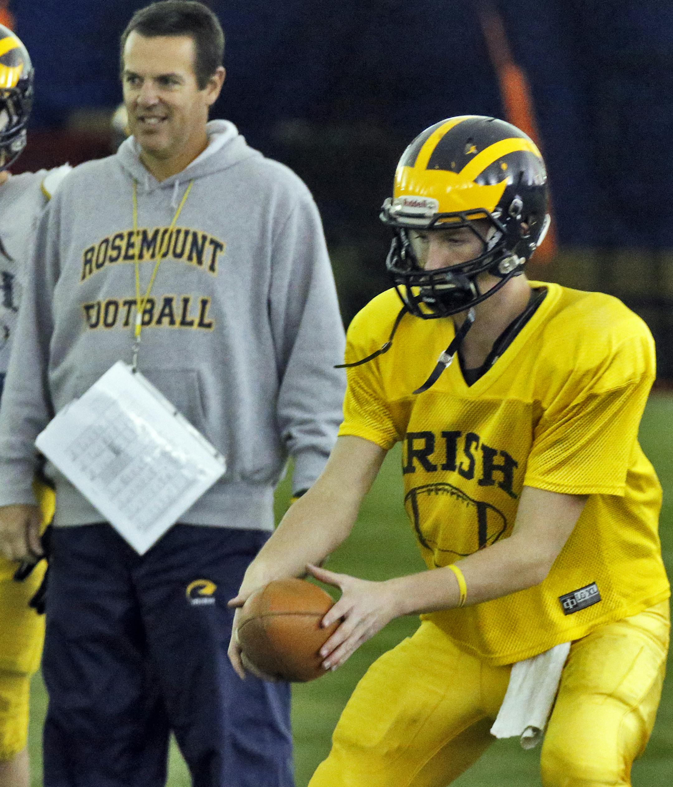 Rosemount football team prepared for upcoming 6A Prep Bowl championship game with Eden Prairie. NOTE: Players Dimitri Williams and Craig Szymanski did not practice due to injuries. Good recent photos of Williams in photo archives. Head coach Jeff Erdmann watches his son Jackson Erdmann take a practice snap as quarterback. (MARLIN LEVISON/STARTRIBUNE(mlevison@startribune.com)