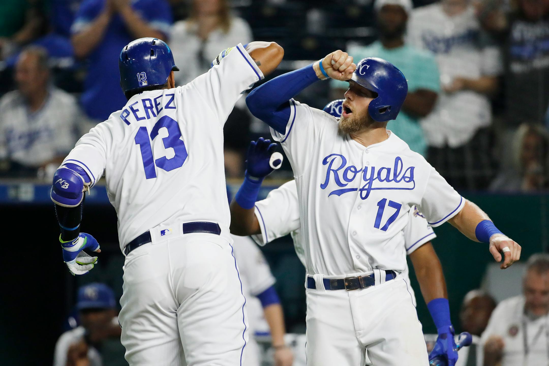 Kansas City Royals' Salvador Perez is congratulated at home plate by Hunter Dozier after hitting a two-run home run in the sixth inning