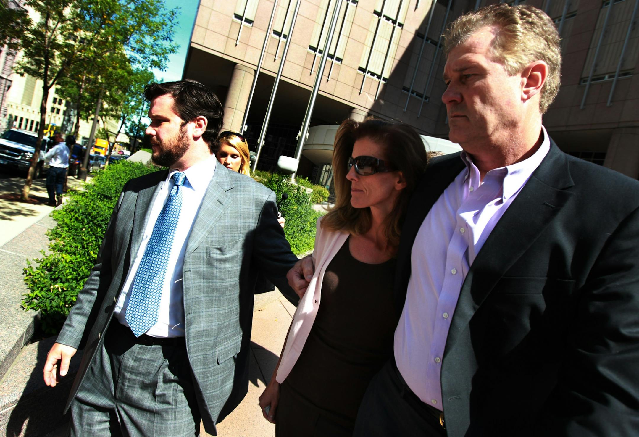 Flanked by her attorney Eric Nelson and husband Joe Senser, Amy Senser walked out of the Hennepin County Jail in downtown Minneapolis on Thursday, Sept. 15, 2011, after posting bond.