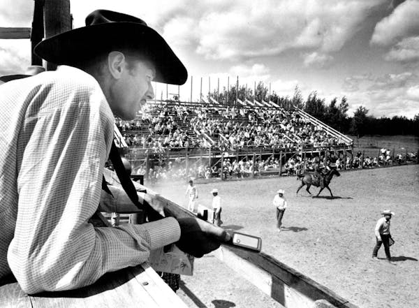 This year's North Star Stampede rodeo will be held without spectators. Here, founder Howard Pitzen announces the action in 1965.