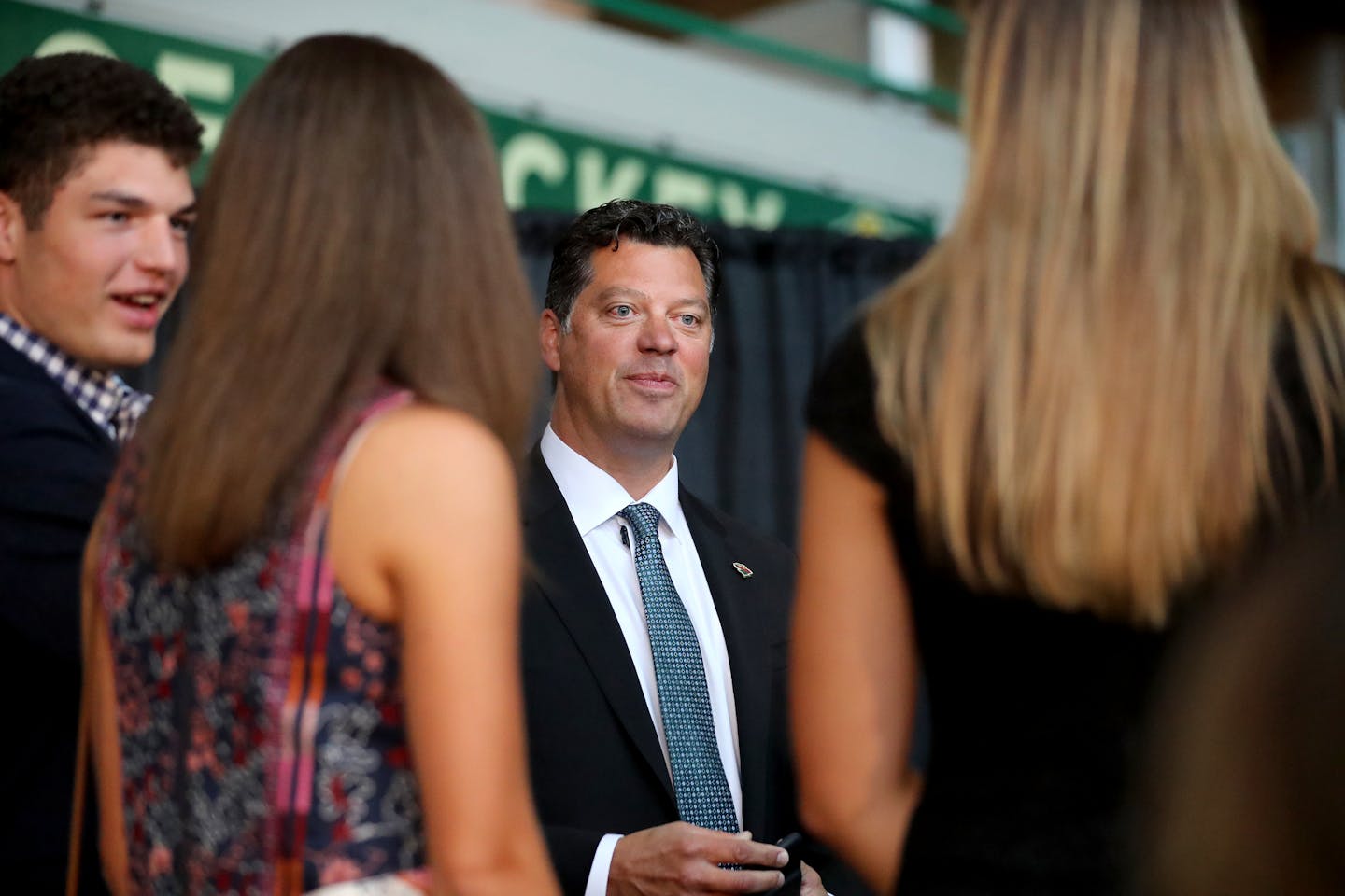 Bill Guerin chatted with his family before being introduced as Wild GM on Thursday at Xcel Energy Center.