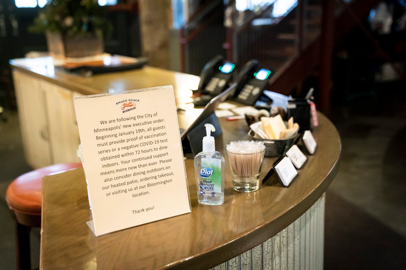 A sign about the mask and vaccination mandate is posted at the hostess desk at the Smack Shack on Friday, Jan. 21, 2022 in Minneapolis, Minn. ] RENEE JONES SCHNEIDER • renee.jones@startribune.com