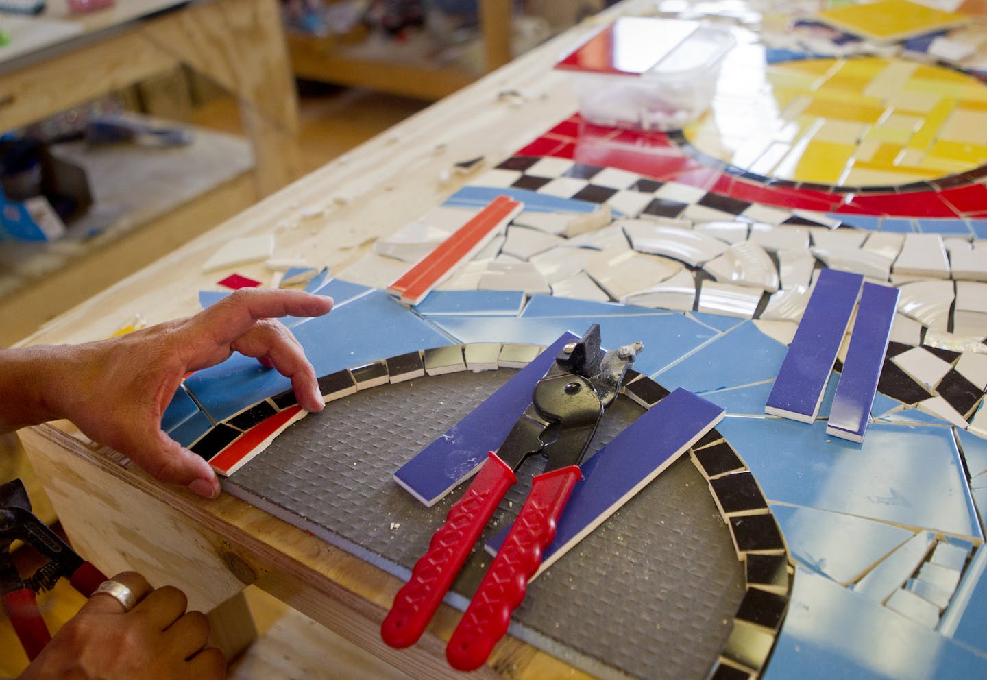 Greene, an artist, works on a commissioned piece for a restaurant in Dubai during free studio time at Mosaic On A Stick. She has renovated the interior of the building to open up the walls and expose the maple flooring.