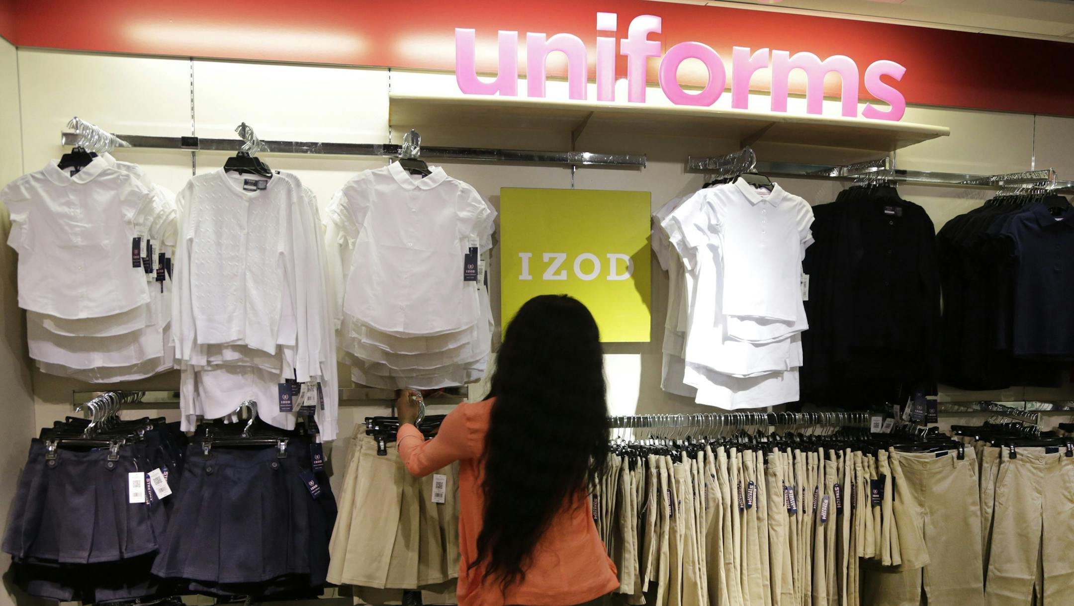 In this July 31, 2013, photo, school uniforms by Izod are displayed at JC Penney in New York. Shoppers, worried about their finances, showed they were more interested in buying discounted summer merchandise in July than in picking up new fall clothing for their children, according to figures released Thursday, Aug. 8, 2013. (AP Photo/Mark Lennihan)