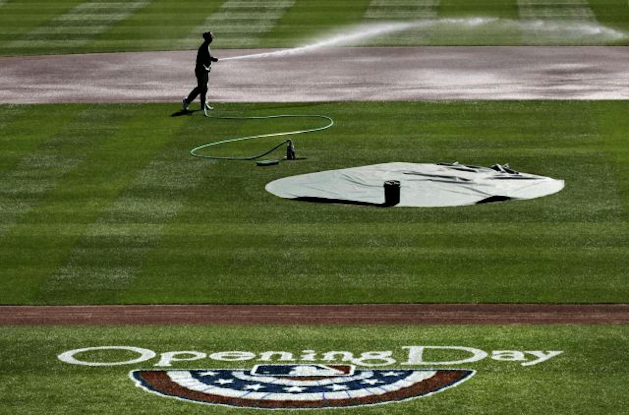 Head grounds keeper Larry DiVito sprays the infield of Target Field, Thursday afternoon in preparation of opening day.