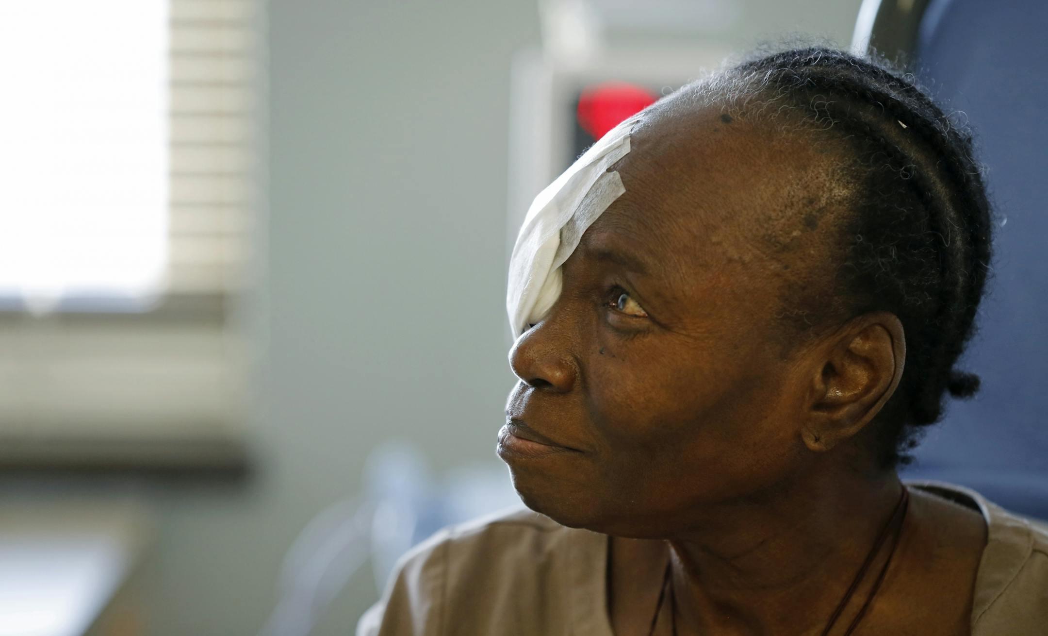 Philomena Faji received post-operation directions in a recovery room after having a cataract removed from her right eye.