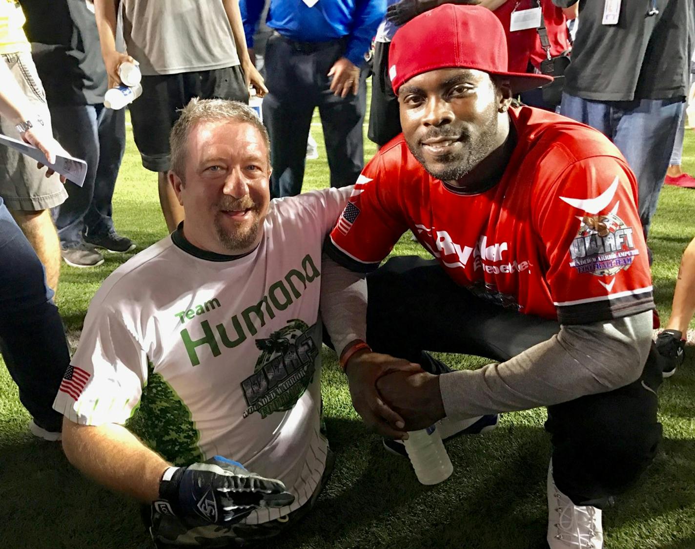 Dave Stevens, with Michael Vick at the NFL alumni vs. wounded warrior amputee game before last year&#xed;s Super Bowl. (Photo courtesy of Stevens)