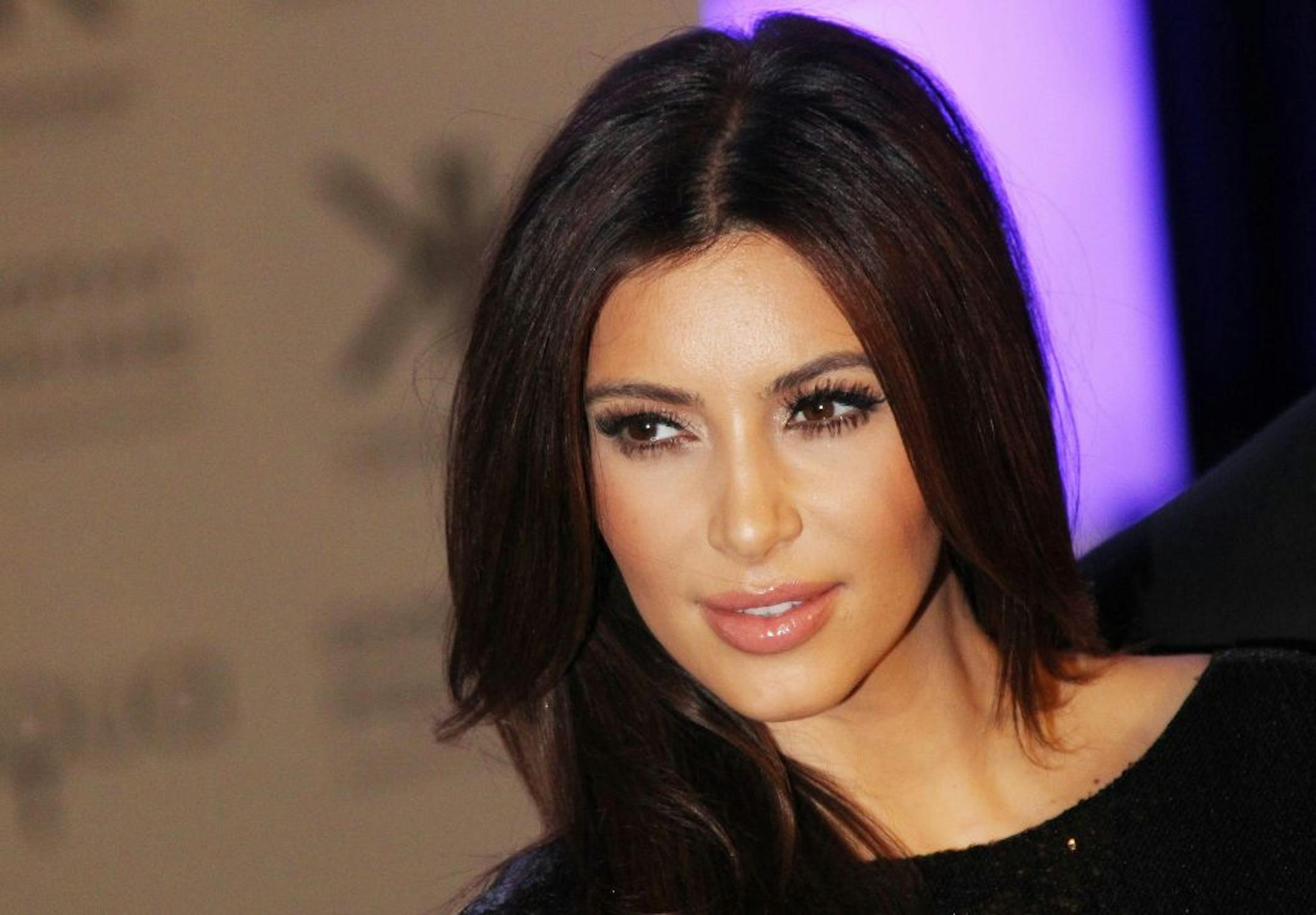 FILE - This Nov. 8, 2012 file photo shows Kim Kardashian at the Kardashian Kollection UK Launch at Acqua Club in central London. As the tabloids speculated over whether or not Jessica Simpson was expecting her second baby and the media zeroed in on Kate Middleton's pregnancy, Kardashian admits it was nice to be away from the glare of the spotlight as she was in the early stages of her own pregnancy. Now that the word is out, 32-year-old Kardashian says her motherly instincts have made her pull b