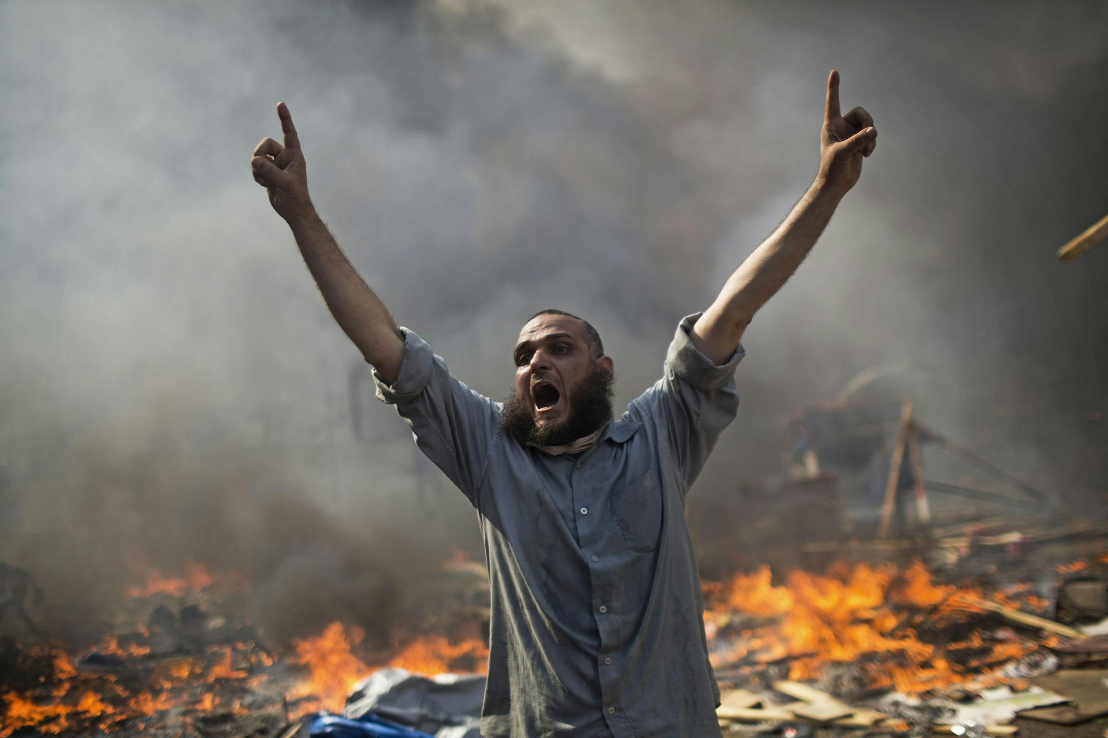 FILE - In this Wednesday, Aug. 14, 2013 file photo, a supporter of ousted Islamist President Mohammed Morsi shouts during clashes with Egyptian security forces in Cairo's Nasr City district, Egypt. At least 624 people were killed during 12 hours of mayhem in Cairoís Rabaah el-Adawiyah Square, though rights groups have said the toll may be several hundred higher. (AP Photo/Manu Brabo, File)