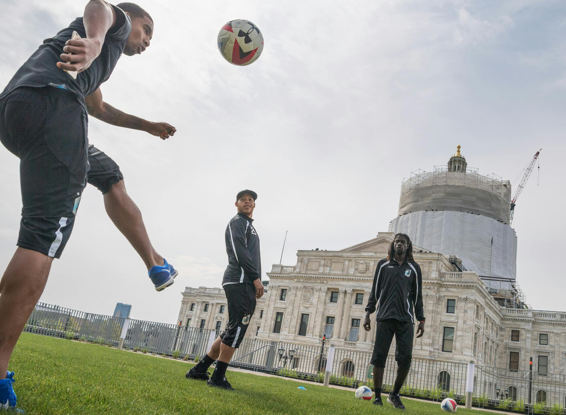 Players Stefano Pinho, J.C. Banks and Ismaila Jome moved a ball around the Senate Office Building lawn as Mayor Coleman and Senate President Sandra Pappas spoke.