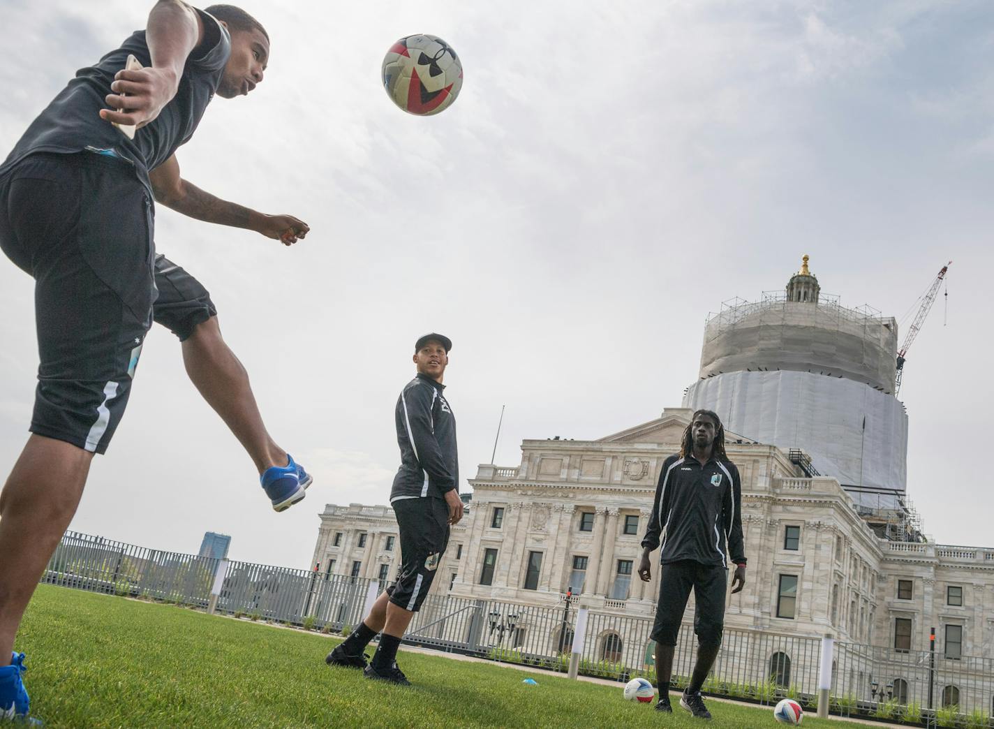 Players Stefano Pinho, J.C. Banks and Ismaila Jome moved a ball around the Senate Office Building lawn as Mayor Coleman and Senate President Sandra Pappas spoke. ] GLEN STUBBE * gstubbe@startribune.com Monday, May 9, 2016 Minnesota United FC players will hold a team "warm up" outside the State Capitol, urging lawmakers to support bringing Major League Soccer to Minnesota. Soccer team members ran warm-up drills on the Minnesota Senate Building Plaza, which overlooks the state capitol, and engage