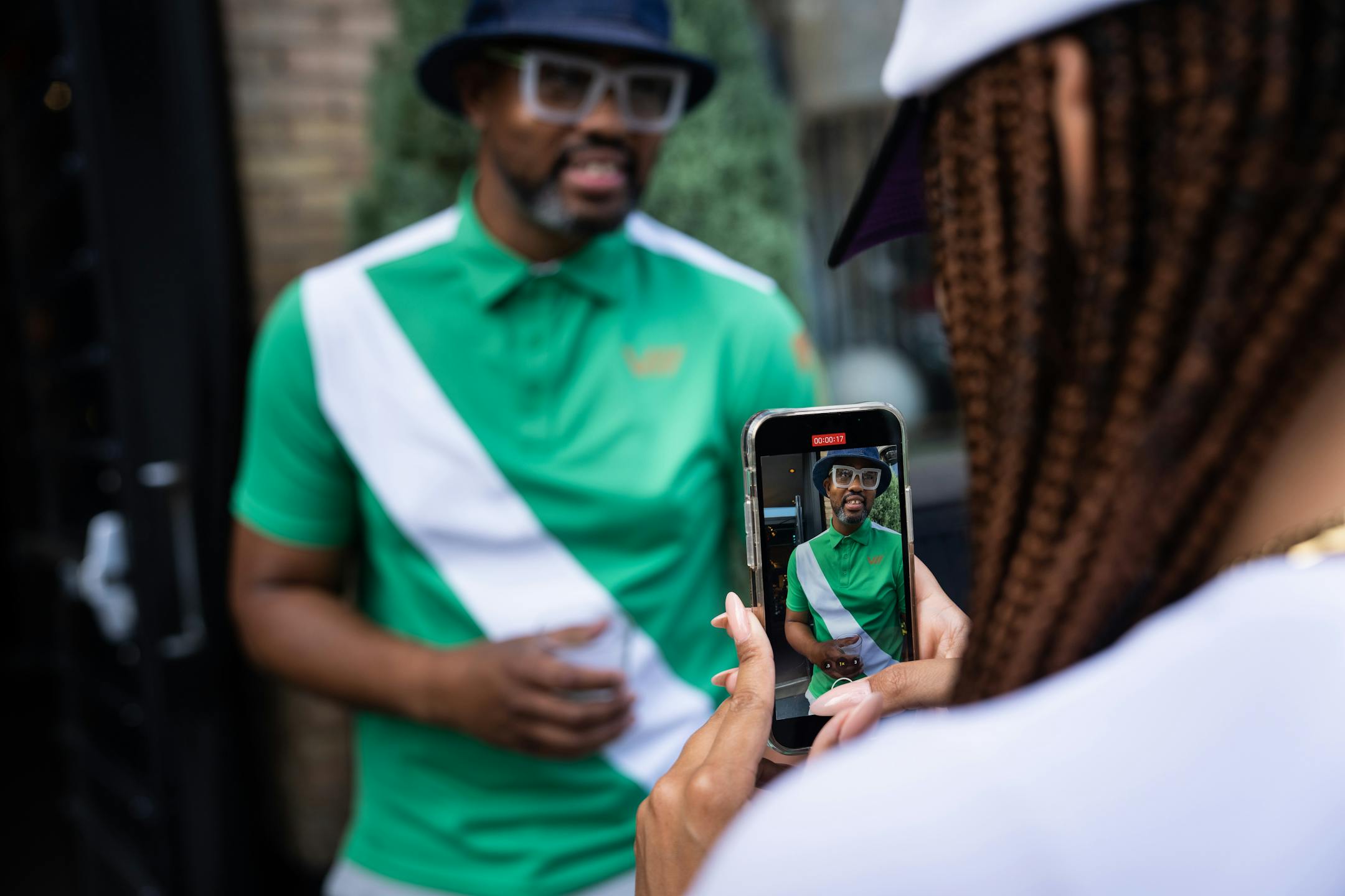 Social media manager Sophia Stewart records Houston White for a social media post at a pop up event at Martin Patrick 3 for White's high-end Viictory sportswear collection in June.