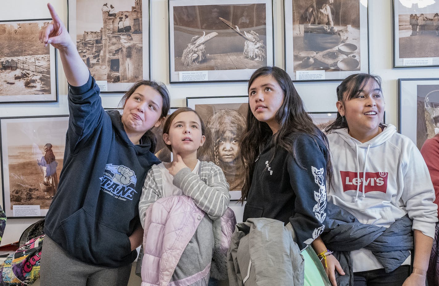 Le Center sixth-graders Cristina Cruz, Marissa Schroeder, Lupita Lopez and Melogy Morales Mendez take in the works of Edward S. Curtis, whose photographs are on display in Montgomery, Minn. Curtis spent his boyhood in Le Seuer County and went on to become the most renowned photographer of the American Indian.