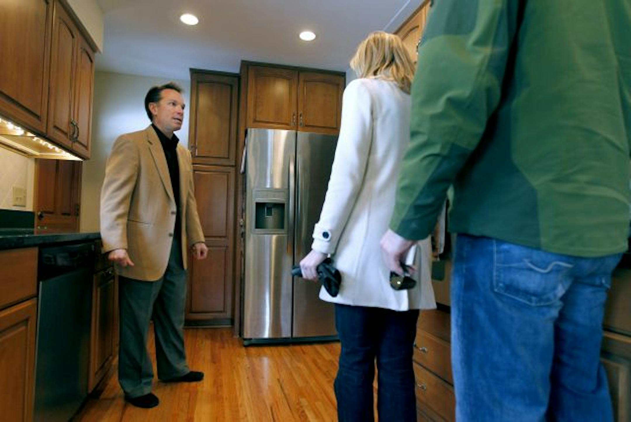 Realtor Gary Judson spoke with a couple looking through an Edina home during a recent open house.