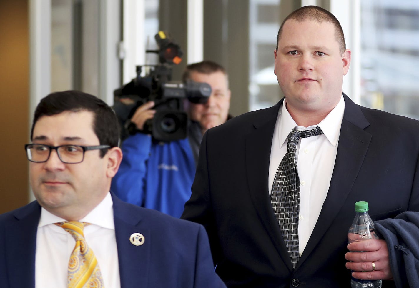 Former Minneapolis police officer Christopher Reiter, 36, right, arrives at court with his attorney Robert Fowler Thursday, March 16, 2017, at the Hennepin County Jail in Minneapolis, Minn. Reiter is accused of kicking a suspect who was on his hands and knees during an incident in spring of 2016. (David Joles /Star Tribune via AP)