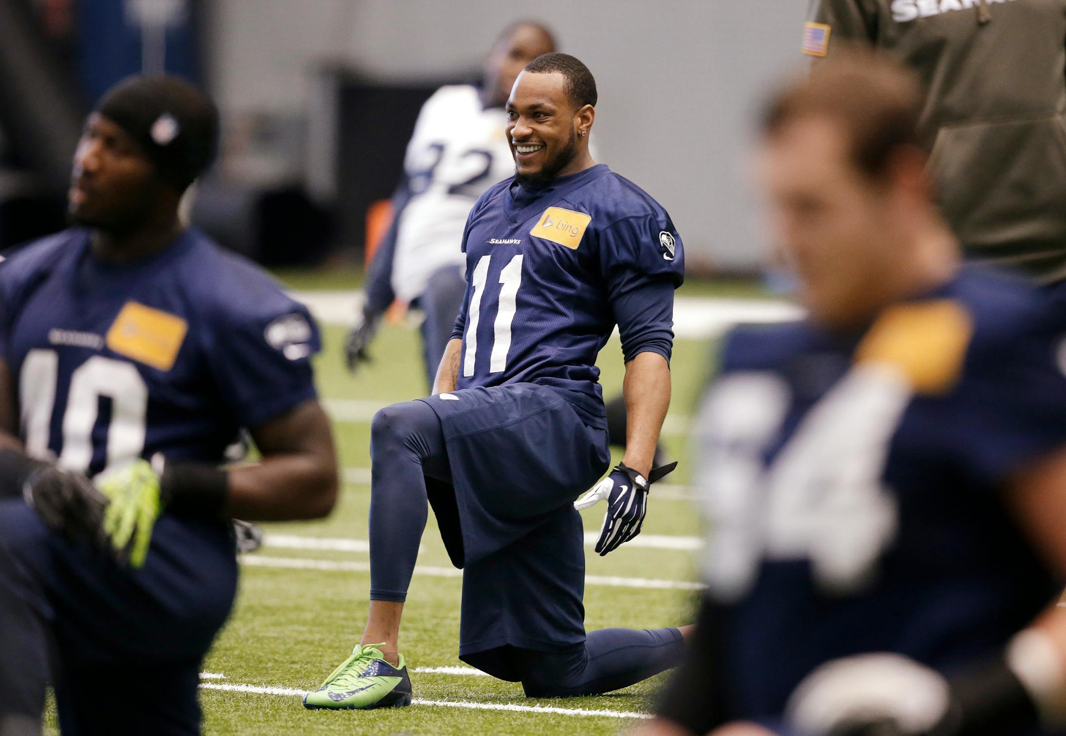 Seattle Seahawks' Percy Harvin (11) smiles as he stretches during NFL football practice Tuesday, Jan. 7, 2014, in Kirkland, Wash. The Seahawks host the New Orleans Saints on Saturday in an NFC divisional playoff game. (AP Photo/Elaine Thompson)