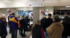 Republican caucus goers line up at Bloomington Jefferson High School to find their precinct Tuesday, March 1, 2016, in Bloomington, Minn. (AP Photo/Ji