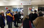 Republican caucus goers line up at Bloomington Jefferson High School to find their precinct Tuesday, March 1, 2016, in Bloomington, Minn. (AP Photo/Ji