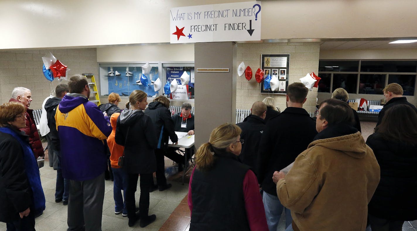 Republican caucus goers line up at Bloomington Jefferson High School to find their precinct Tuesday, March 1, 2016, in Bloomington, Minn. (AP Photo/Jim Mone) ORG XMIT: MIN2016030214162941