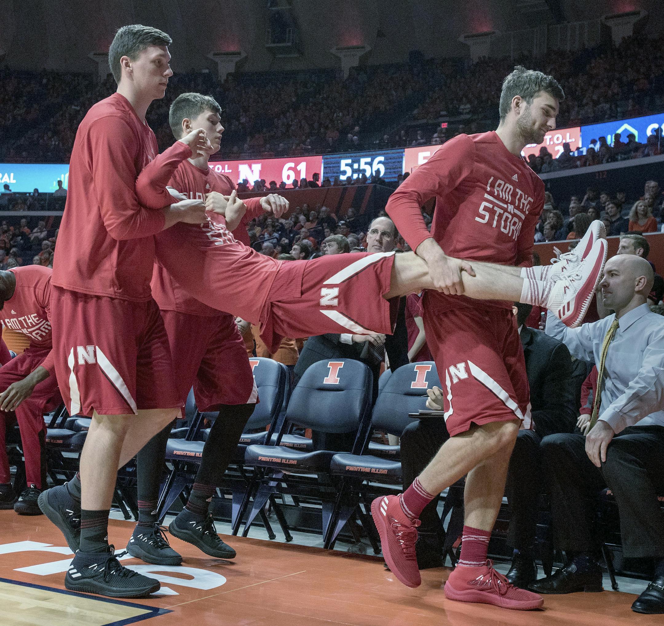 Nebraska bench players carry off a team mate in a skit after a shot was made during the second half of an NCAA college basketball game in Champaign, Ill., on Sunday, Feb.18, 2018. Illinois won 72-66. (AP Photo/Rick Danzl)