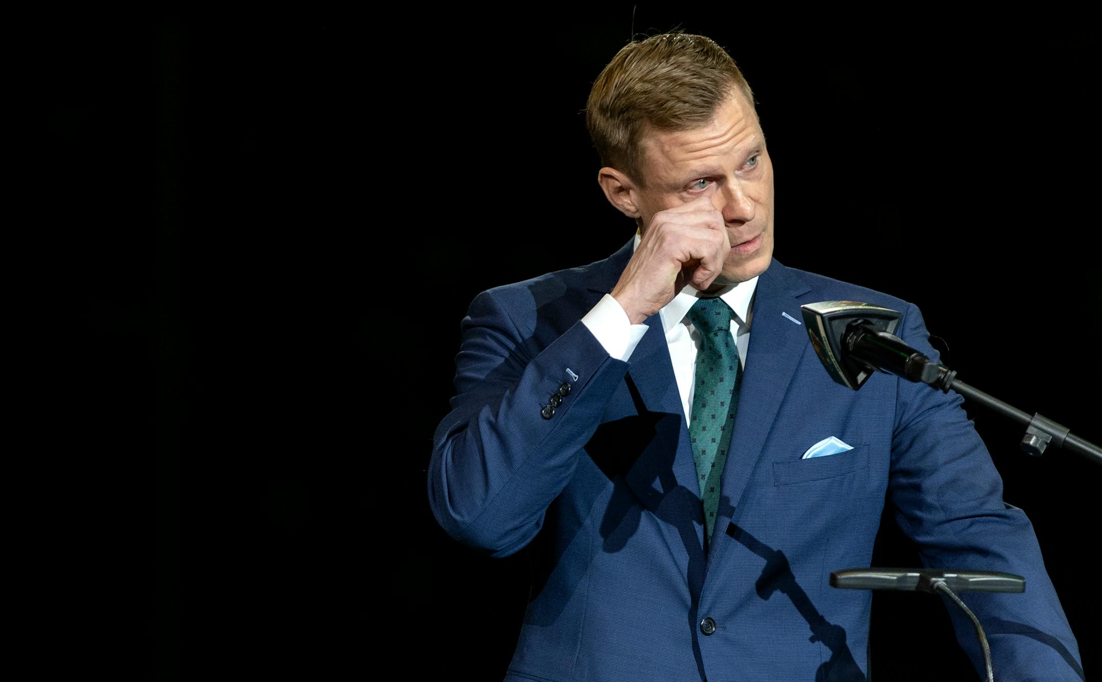 Mikko Koivu collects himself while talking about his children during a ceremony to retire his number.