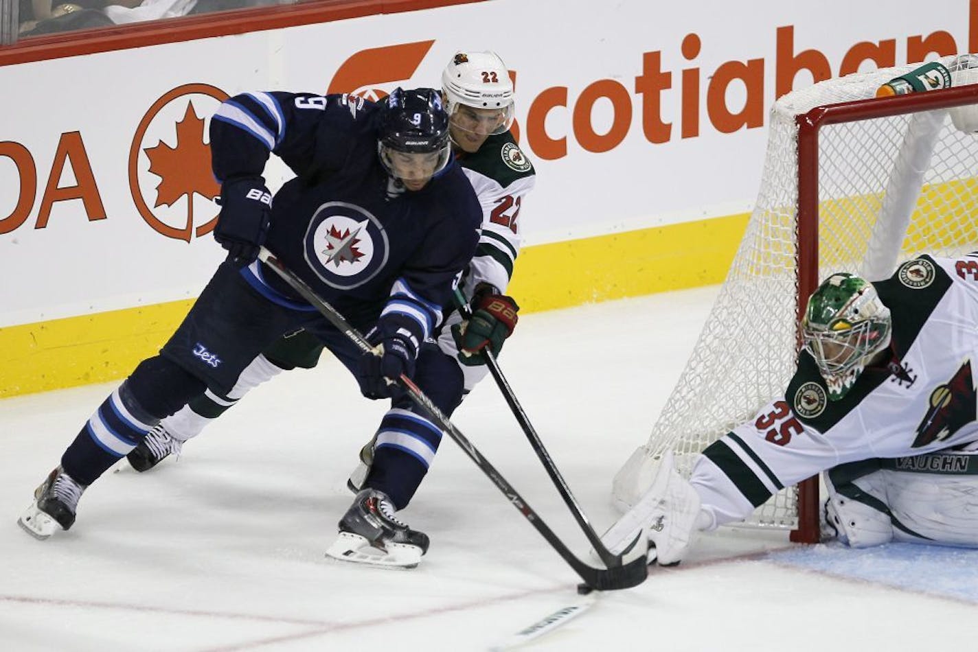 Minnesota Wild's Nino Niederreiter (22) and goaltender Darcy Kuemper (35) shut down Winnipeg Jets' Evander Kane (9) who tries to shoot a wraparound during third-period preseason NHL hockey game action in Winnipeg, Manitoba, Thursday, Sept. 19, 2013.