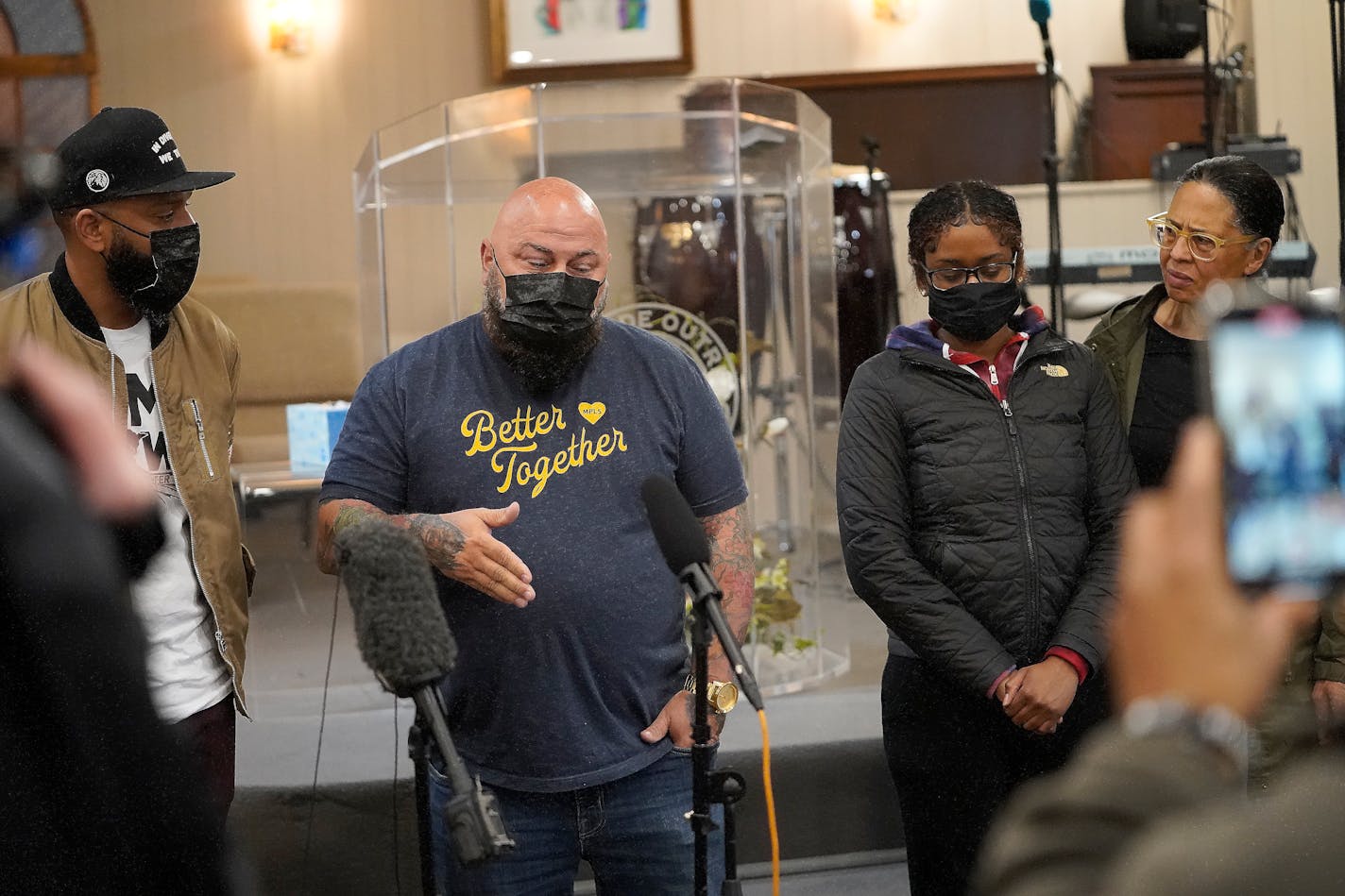 Brian Ingram of One Restaurant Group, second from left, gets emotional while presenting a check for $17,000 to Chyna Whitaker, second from right, the mother of a 1-and-a-half-year-old son with Daunte Wright. The money was raised by Black businesses and restaurants and community members and presented to Whitaker at Worldwide Outreach For Christ Ministries at 38th and Chicago Avenue Wednesday in Minneapolis. Looking on is Pamela Farrar of Worldwide Outreach For Christ Ministries, right, and renown local chef Justin Sutherland, left. ]