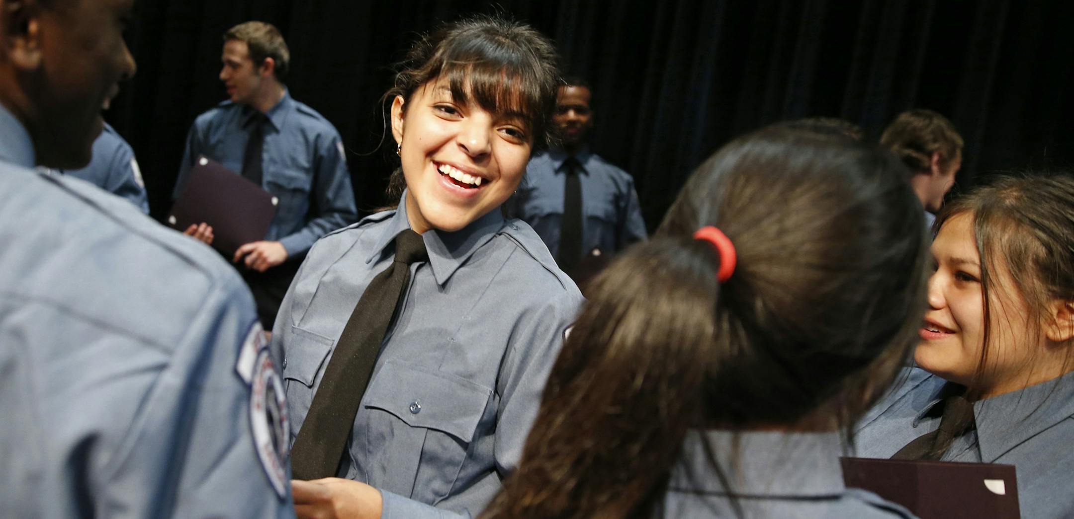 At the Wellstone Center in St. Paul, the Saint Paul EMS Academy graduated 17 EMT's including Alaina Carrion, second from left, who was also chosen as a keynote speaker .]tsong-taataarii@startribune.com ORG XMIT: MIN1308271922547655