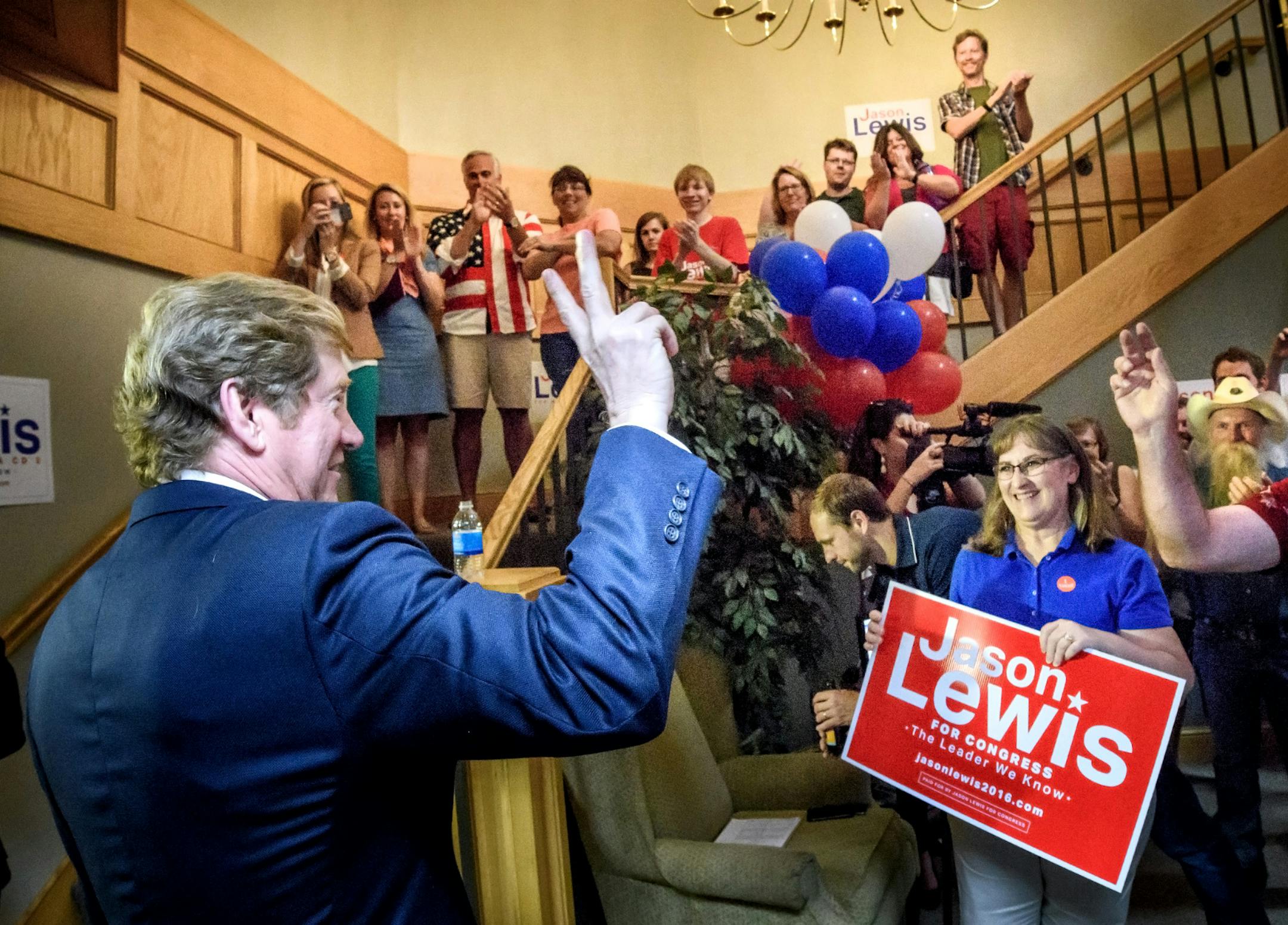 GOP primary candidate Jason Lewis flashed the victory sign to supporters Tuesday night.