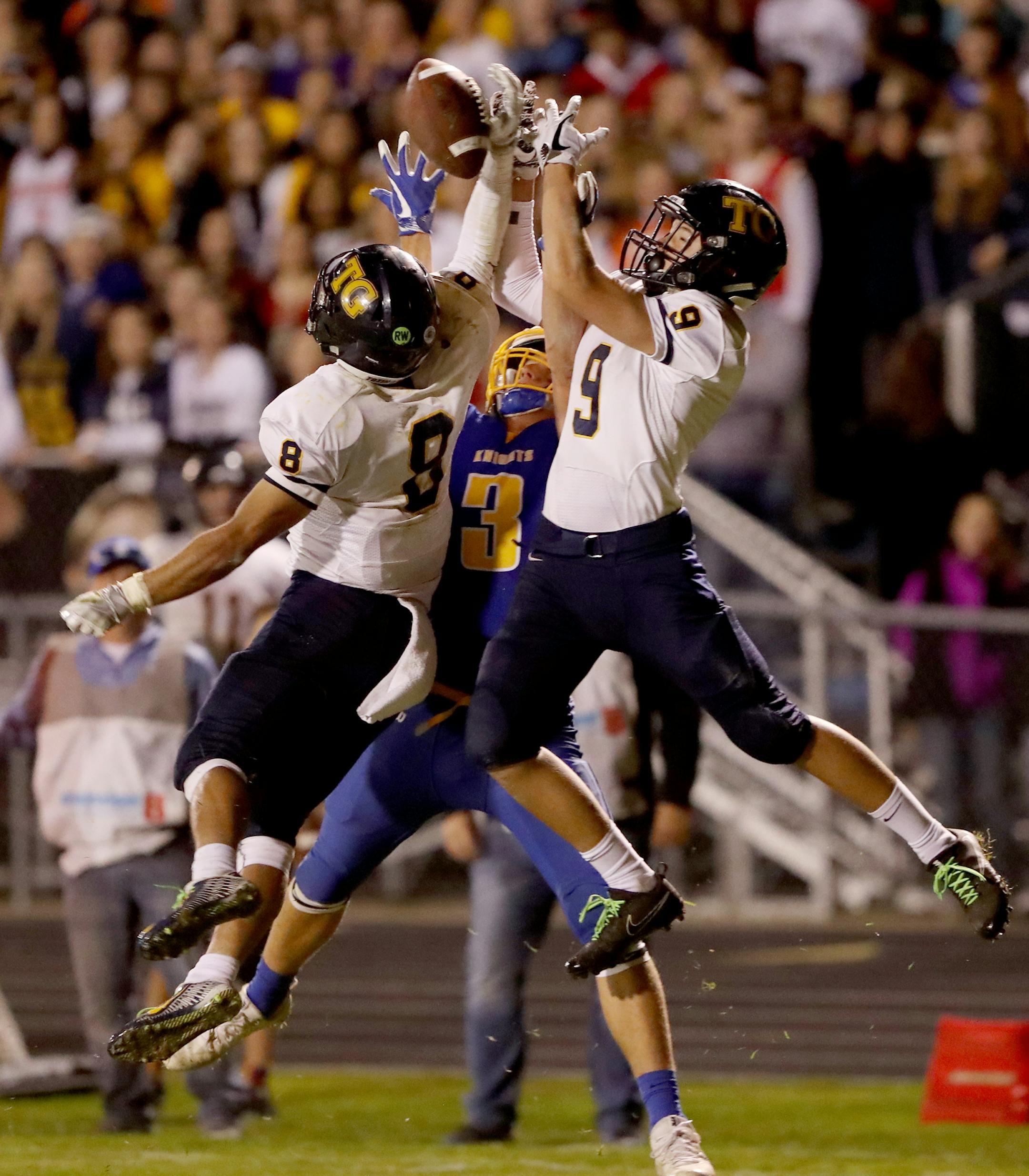 Totino-Grace's Ryan Suggs (8) and Sam Quick (9) break up a fourth down pass intended for St. Michael-Albertville's Zach Sjelin (3) with under a minute to go in Totino-Grace's 12-7 win over St. Michael-Albertville Friday, Sept. 30, 2017, in Albertville, MN.] DAVID JOLES ï david.joles@startribune.com Totino-Grace vs. St. Michael-Albertville prep football