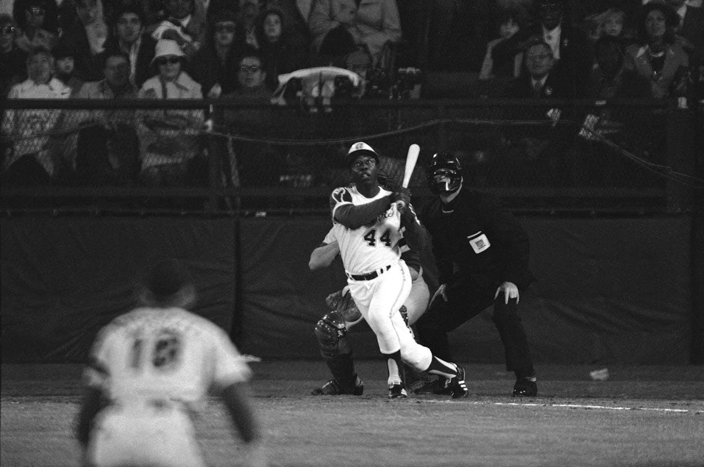 Atlanta Braves' Hank Aaron eyes the flight of the ball after hitting his 715th career homer in a game against the Los Angeles Dodgers in Atlanta, Ga., Monday night, April 8, 1974. Aaron broke Babe Ruth's record of 714 career home runs. Dodgers southpaw pitcher Al Downing, catcher Joe Ferguson and umpire David Davidson look on. (AP Photo/Harry Harrris) ORG XMIT: APHS020900