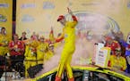 Joey Logano celebrates in Victory Lane after winning the NASCAR All-Star auto race at Charlotte Motor Speedway in Concord, N.C., Saturday, May 21, 201
