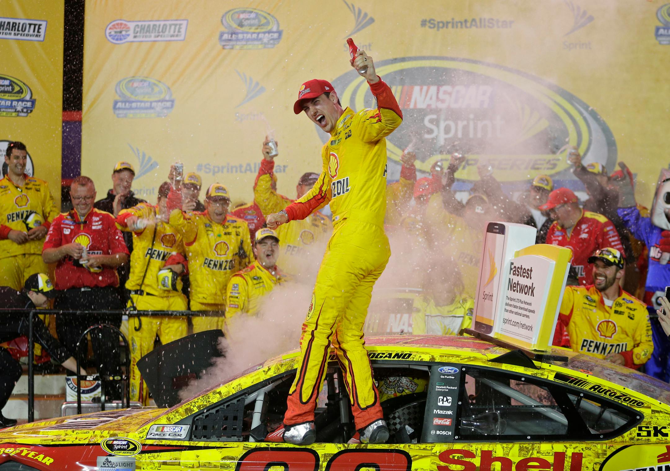 Joey Logano celebrates in Victory Lane after winning the NASCAR All-Star auto race at Charlotte Motor Speedway in Concord, N.C., Saturday, May 21, 2016. (AP Photo/Chuck Burton)
