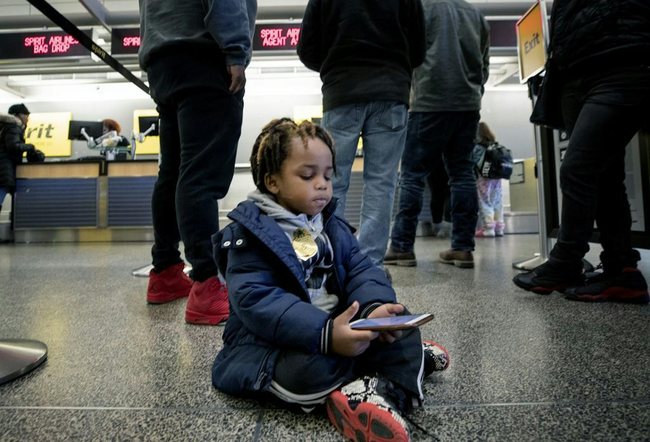 Montezz Lesure, 5, of Rochester waited in line to check in for a flight with his mother at the Minneapolis-Saint Paul International Airport.