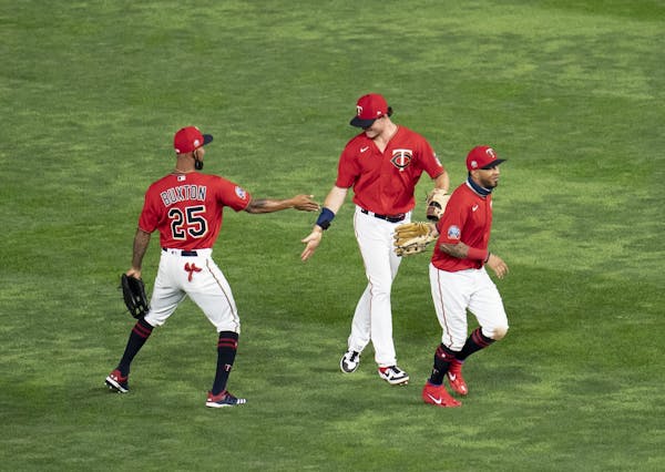 Twins players celebrated their 4-1 win of Cleveland with air high fives.