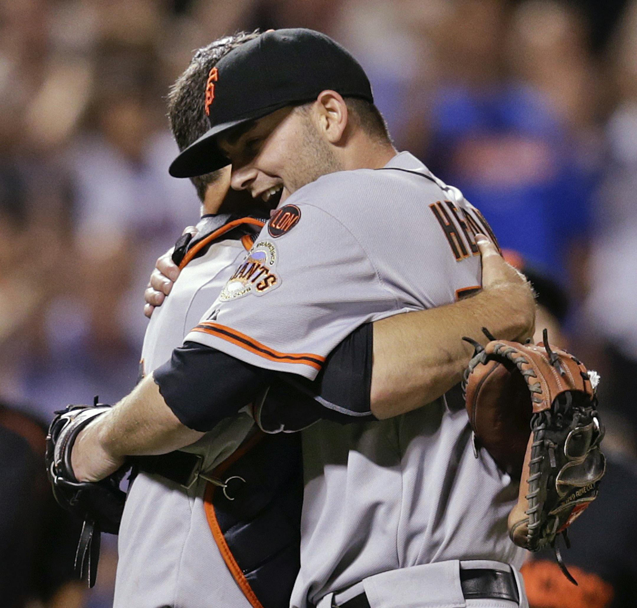 San Francisco Giants pitcher Chris Heston, right, hugs Buster Posey after he threw a no-hitter against the New York Mets in a baseball game Tuesday, June 9, 2015, in New York. The Giants won 5-0. (AP Photo/Frank Franklin II) ORG XMIT: MIN2015083118592549