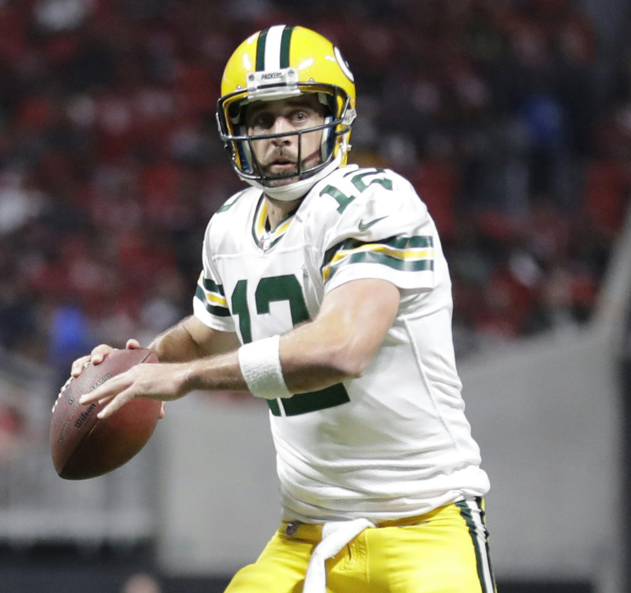 Green Bay Packers quarterback Aaron Rodgers (12) runs out of the pocket against the Atlanta Falcons during the second of an NFL football game, Sunday, Sept. 17, 2017, in Atlanta. (AP Photo/David Goldman) ORG XMIT: MIN2017101317283944