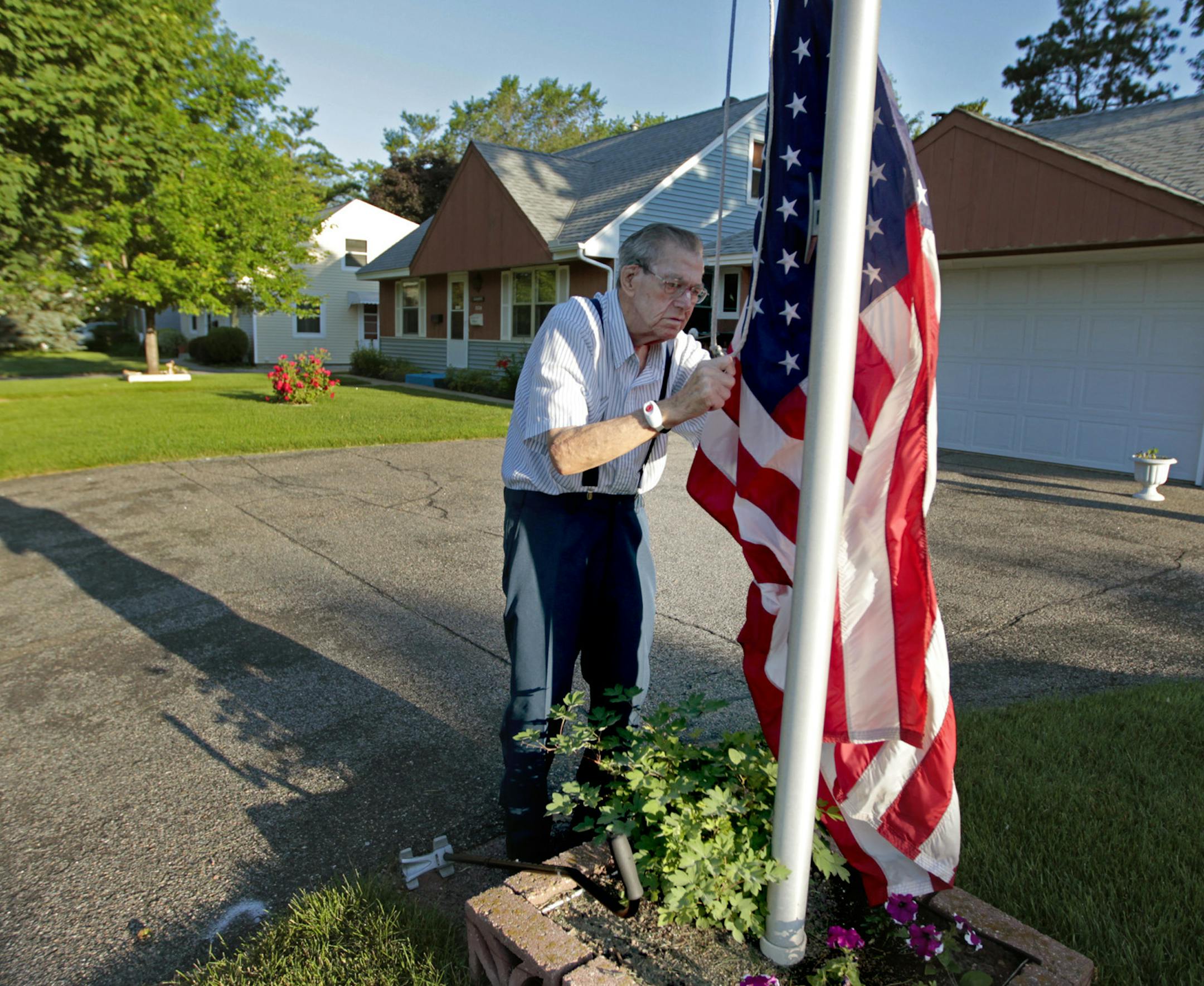 Warren Bushway, 93, hung a flag early Tuesday morning, June 24, 2014 in St. Louis Park, MN. ] (ELIZABETH FLORES/STAR TRIBUNE) ELIZABETH FLORES • eflores@startribune.com