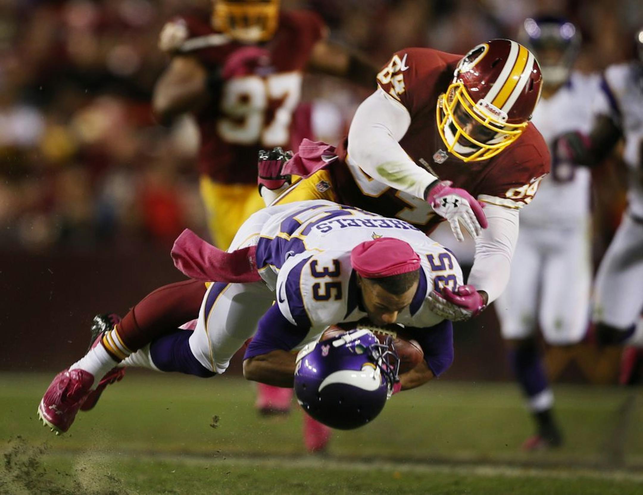 Marcus Sherels in the punt return trenches, hit by Washington's Niles Paul.