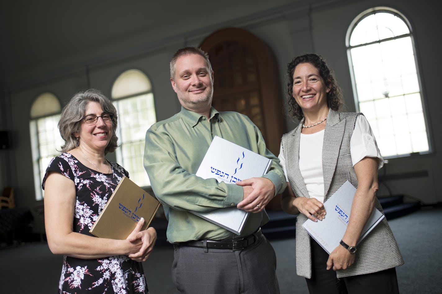 From left, Shir Tikvah Director of Spiritual engagement Wendy Goldberg, Rabbi Michael Adam Latz and Associate Rabbi Debra Rappaport were photographed with the new Mishkan HaNefesh prayer books in the sanctuary of Shir Tikva on Monday afternoon. ] Aaron Lavinsky &#x2022; aaron.lavinsky@startribune.com This Rosh Hashanah and Yom Kippur, some Reform congregations around the country will be using a new prayer book - Mishkan HaNefesh - that overhauls the traditional prayer book by including gender ne