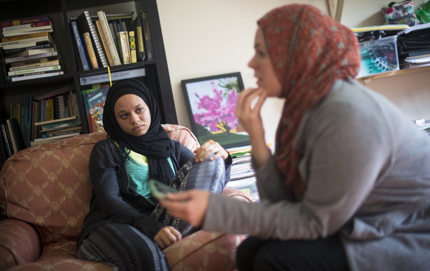 15-year-old Amaiya Zafar listened as her mother, Sarah O'Keefe, explained the custom of Muslim women covering their bodies for modesty in their home Wednesday.