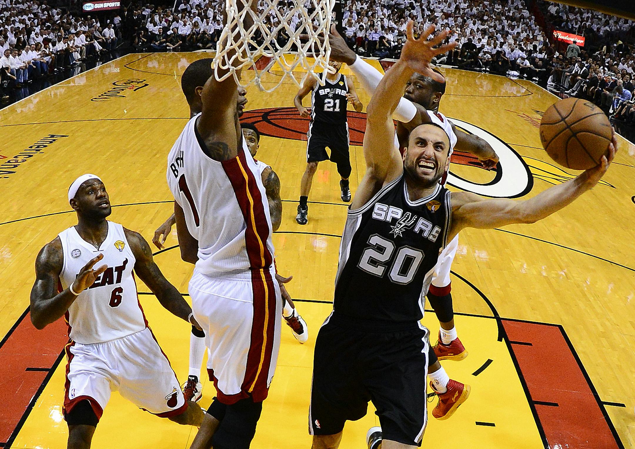 San Antonio Spurs shooting guard Manu Ginobili (20) shoots against Miami Heat center Chris Bosh (1)during the first half of Game 2 in the NBA Finals basketball game, Sunday, June 9, 2013 in Miami. The Miami Heat won 103-84. (AP Photo/Larry W. Smith, Pool) ORG XMIT: MIN2013061114330378