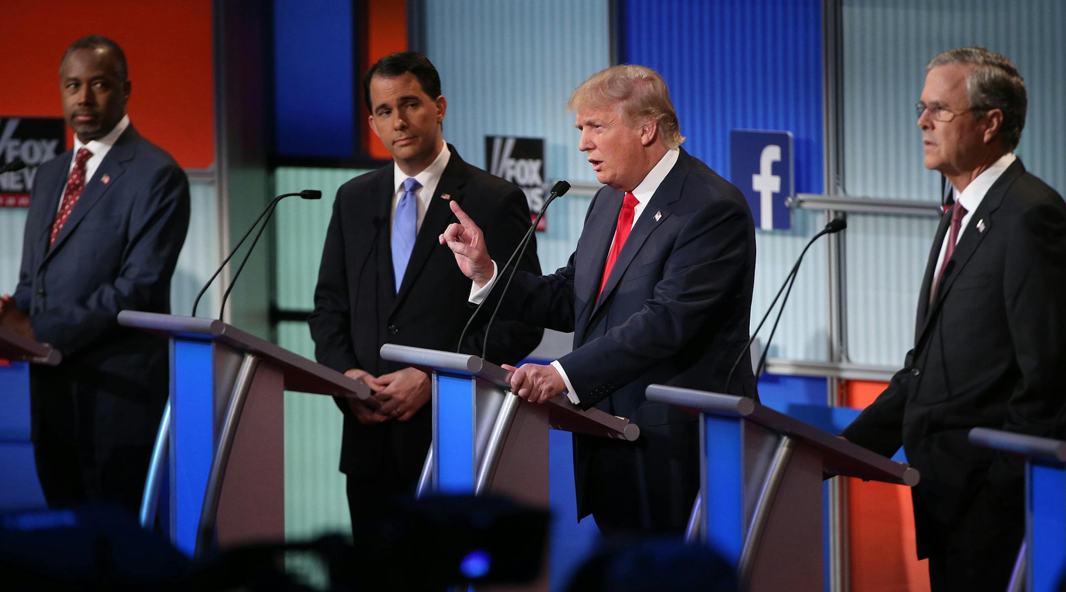 Donald Trump, the real estate mogul and television personality, speaks during the first debate of ten leading Republican presidential hopefuls, at the Quicken Loans Arena in Cleveland, Aug. 6, 2015. From left: Ben Carson, the retired neurosurgeon and political commentator, Gov. Scott Walker of Wisconsin, Trump and Jeb Bush, the former governor of Florida. (Doug Mills/The New York Times) ORG XMIT: MIN2015080711484119